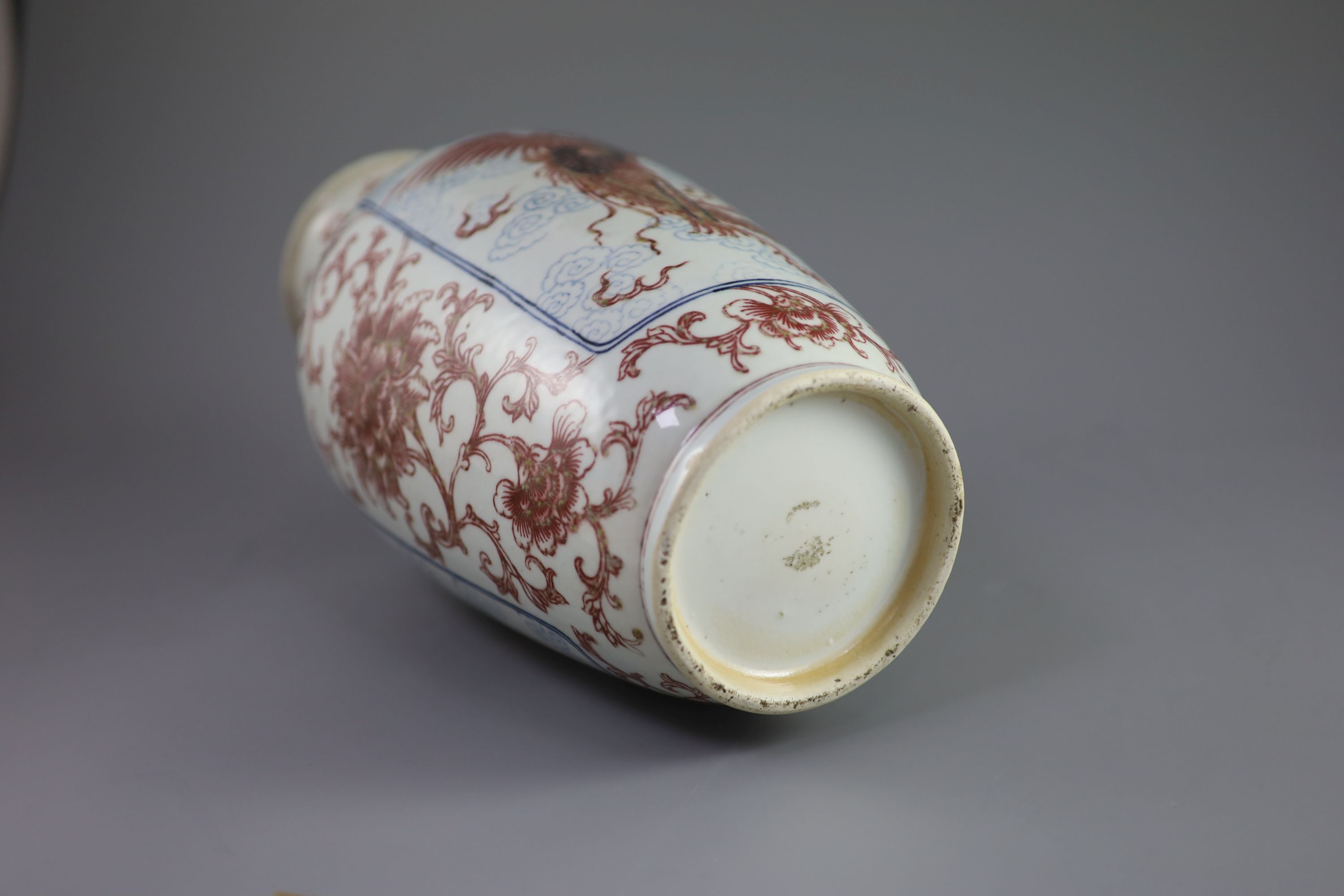 A Chinese underglaze blue and copper red 'dragon and phoenix' vase, Daoguang period (1821-50), 36cm high, rim ground off